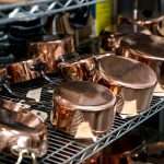 Copper cookware on a shelf