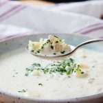 A spoonful of Cullen skink being lifted from the bowl