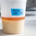 A plastic container of partly solidified bacon fat, labeled