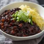 Close-up of a bowl of jjajangmyeon (wheat noodles with black bean sauce)